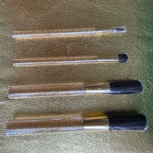 Estée Lauder gold (4) makeup brush set.